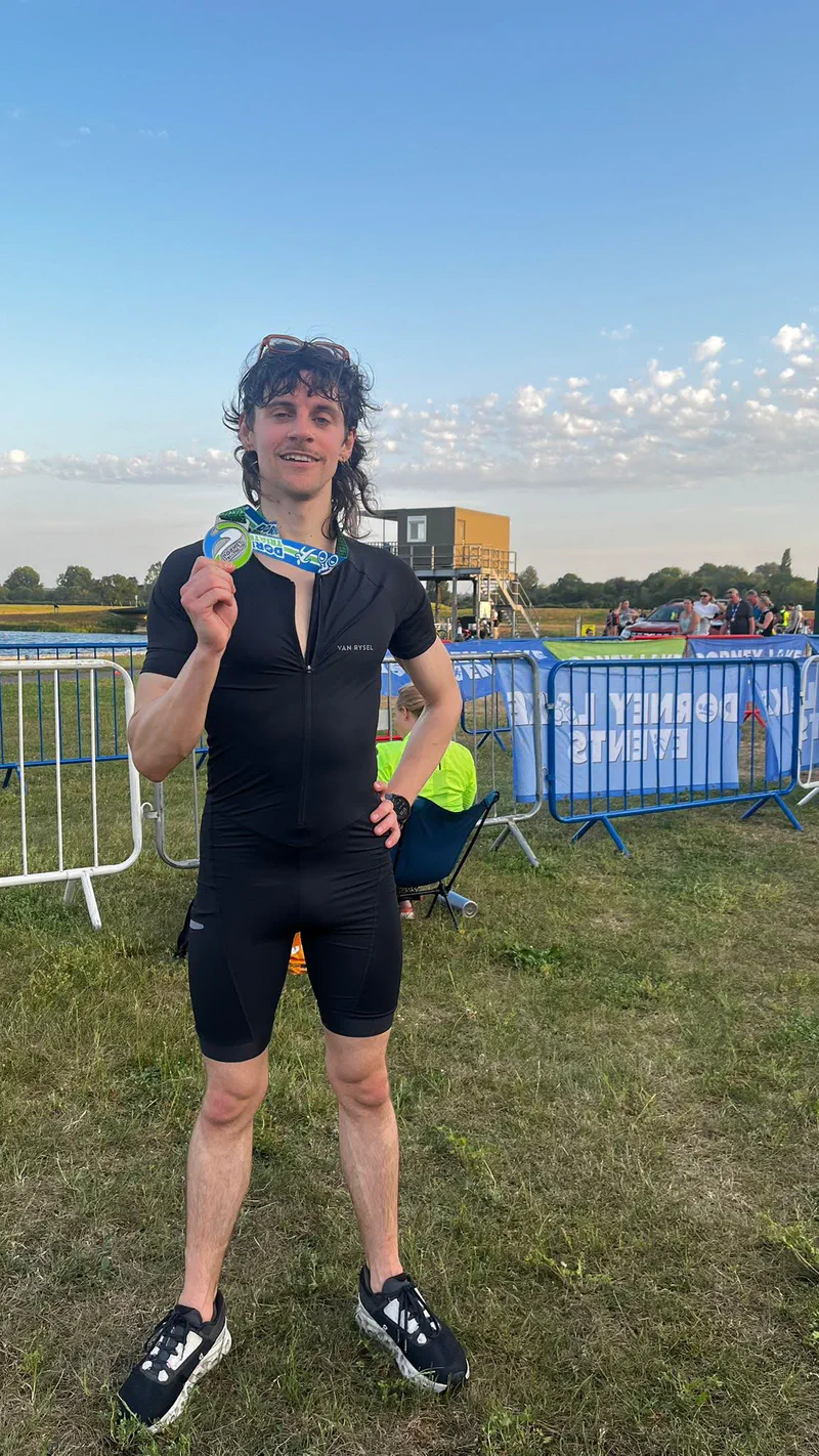 Holding up the finisher's medal at Dorney Lake